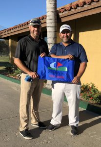 Keiser University student Antonio Rivera (left) with friend Martin Baez after hitting a hole-in-one.